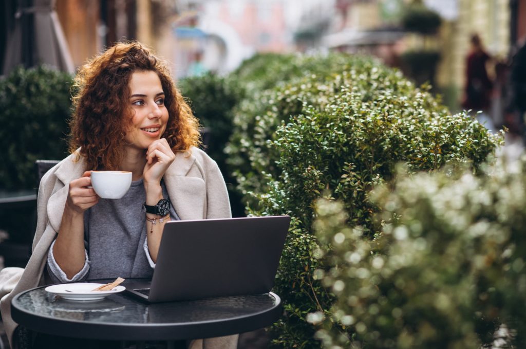 Women working outside with a coffee