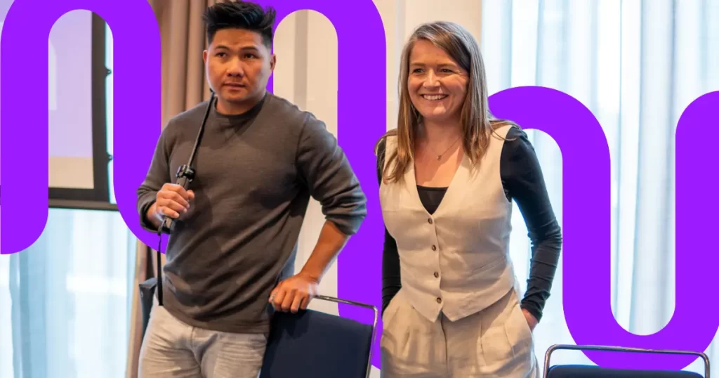 Man and woman stand together at a conference